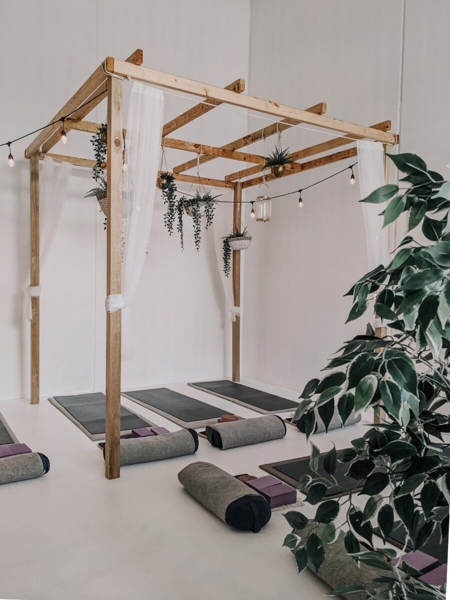 Salle de yoga avec plantes artificielles